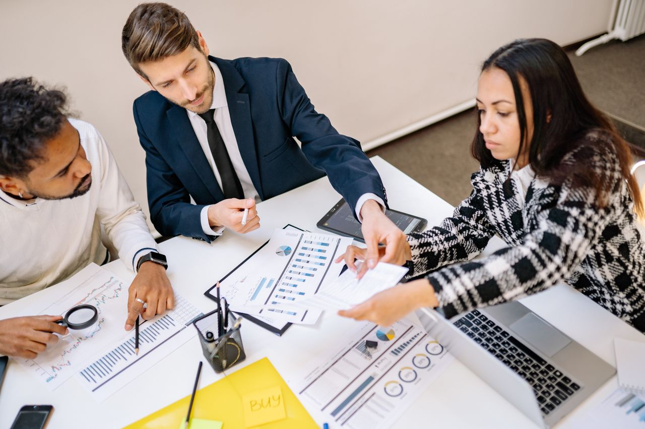 heros-img Business professionals engaging in a collaborative meeting with charts and documents.