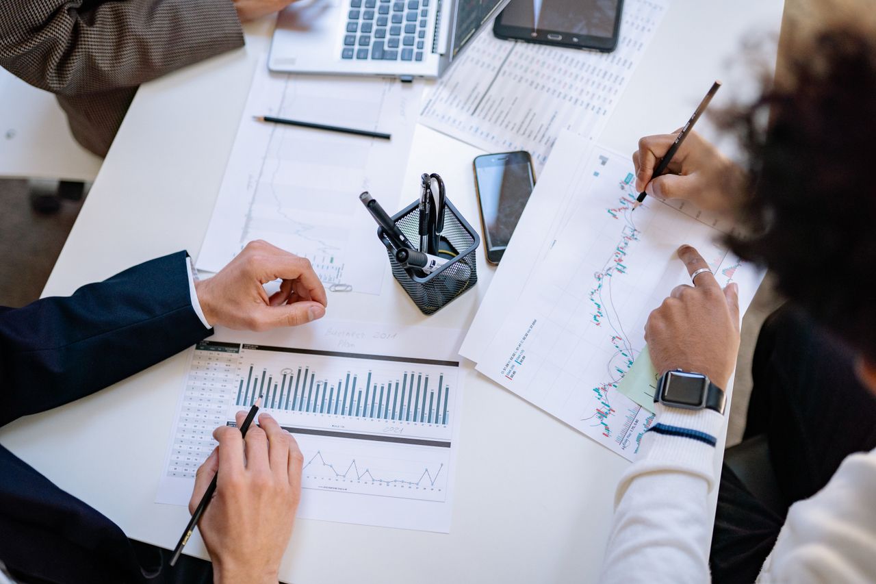 about-us Business team analyzing financial charts and graphs during a collaborative meeting.